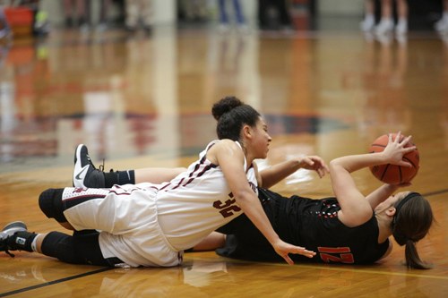 Oak Ridge junior Jaymi Golden (32) battles for a loose ball during a 59-34 win over Powell at Clinton in the District 3-AAA championship at Clinton on Tuesday, Feb. 21, 2017. (Photo by Luther Simmons)
