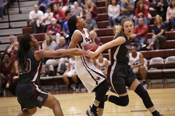 Oak Ridge sophmore Jada Guinn (24), center, had a game high and career high 32 points in a 62-56 win over Bearden in a Region 2-AAA quarterfinal elimination game at Wildcat Arena on Friday, Feb. 24, 2017. Guinn is defended here by 6-foot-2 junior Grace van Rij (44) of Bearden and freshman Keke McLaughlin (20). (Photo by Luther Simmons)