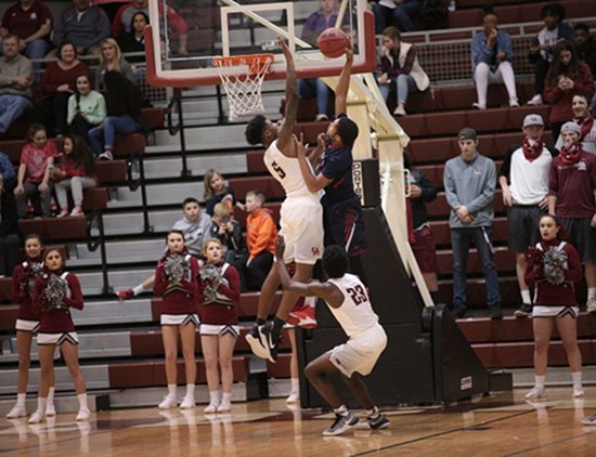 Oak Ridge senior Tee Higgins (5) blocks the basketball during a 68-38 Region 2-AAA quarterfinal win against West at Wildcat Arena on Saturday, Feb. 25, 2017. (Photo by Luther Simmons)