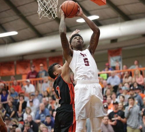 Oak Ridge senior Tee Higgins (5) is pictured above during an 86-58 win over Powell in the District 3-AAA championship at Clinton High School on Tuesday, Feb. 21, 2017. (Photo by Luther Simmons)
