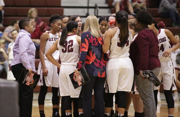 The Oak Ridge Lady Wildcats huddle with Coach Paige Redman during a 62-56 win over Bearden in a Region 2-AAA quarterfinal elimination game at Wildcat Arena on Friday, Feb. 24, 2017. (Photo by Luther Simmons)