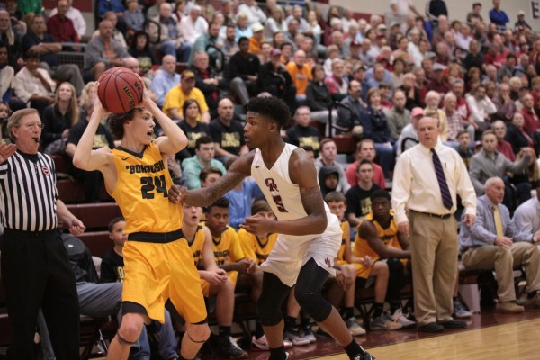 Oak Ridge senior Tee Higgins (5) plays defense against McHale Bright (24) of David Crockett during a 90-60 win for the Wildcats in a Class AAA sectional at Wildcat Arena on Monday, March 6, 2017. (Photo by Luther Simmons)