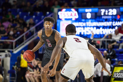 Oak Ridge senior Tee Higgins (5) looks for a pass against Memphis East junior Alex Lomax (2) during a 63-60 loss for the Wildcats in a Class AAA boys' state semifinal game at Murphy Center in Murfreesboro on Friday, March 17, 2017. (Photo by Kindell Moore)