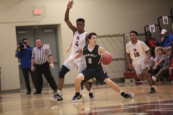 Oak Ridge senior Tyshawn Young (4) plays defense against Maryville senior Easton Upchurch (0), who had a game-high 25 points, with 21 of them from seven three-point shots, during a 46-43 win for Oak Ridge in a Region 2-AAA semifinal elimination game at Wildcat Arena on Tuesday, Feb. 28, 2017. (Photo by Luther Simmons)