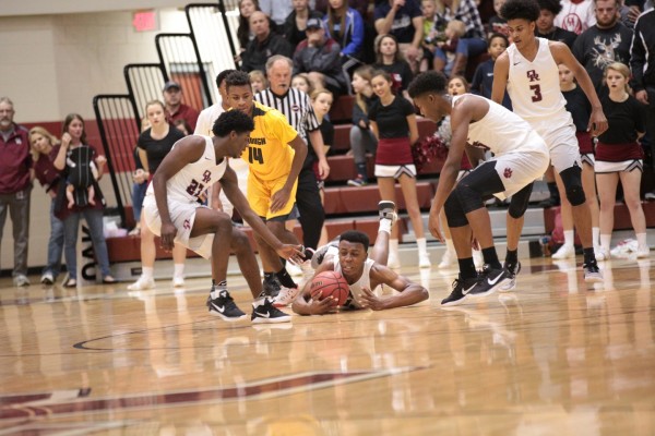 Oak Ridge senior Tyshawn Young (4) fights for a loose ball during a 90-60 win for the Wildcats in a Class AAA sectional at Wildcat Arena on Monday, March 6, 2017. (Photo by Luther Simmons)