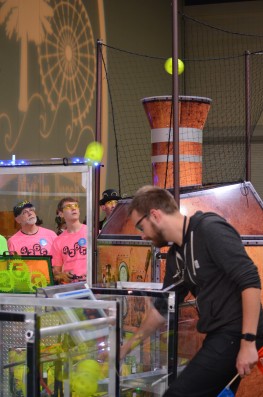 Members of the Secret City Wildbots Team 4265 Drive Team look on as the robot scores high goals with the “fuel” (wiffle balls) picked up from the field at the First Robotics Palmetto Regional in Myrtle Beach, South Carolina, on Friday, March 3, 2017. One point is scored for each ball in the high goal. (Photo by Angi Agle)