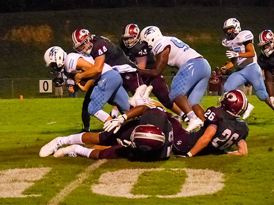 The Oak Ridge defense tackles Hardin Valley junior quarterback Grayson Vaughn (10) at the Wildcats' 10-yard line during a 21-20 win over the Hawks on Blankenship Field on Friday, Aug. 18, 2017. Sophomore linebacker Jacob Adams (44) helps make the stop. (Photo by John Huotari/Oak Ridge Today)