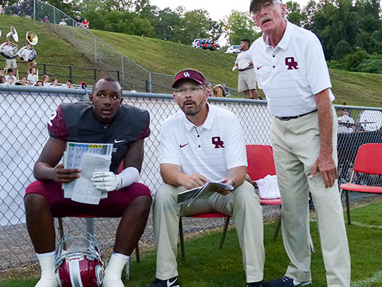 Oak Ridge senior quarterback Johnny Stewart (2) talks to quarterback coach Bryan Wyatt, center, during a 21-20 win over Hardin Valley on Blankenship Field on Friday, Aug. 18, 2017. (Photo by John Huotari/Oak Ridge Today)