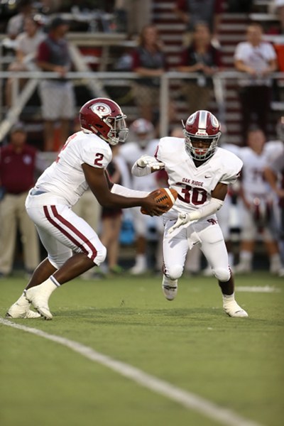 Above, Oak Ridge senior quarterback Johnny Stewart (2) hands off to junior running back Jordan Graham (30) at Dobyns-Bennett in Kingsport on Friday, Aug. 25, 2017. (Photo by Allen Greene Photography)