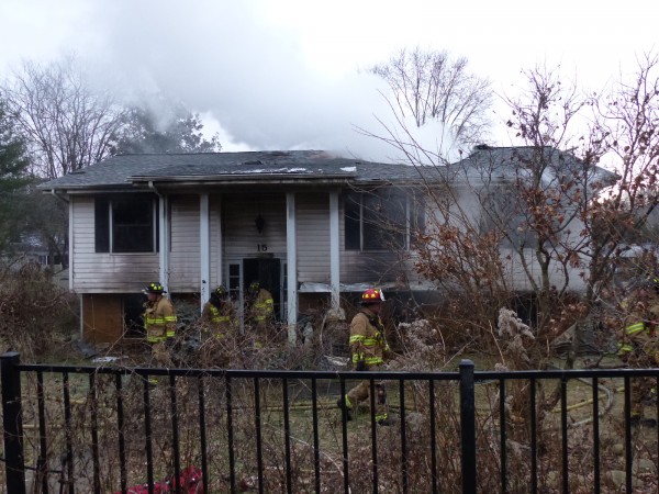 A man escaped with minor injuries, but a home was destroyed in a fire on Friday morning, Jan. 5, 2018, on Lindale Lane in west Oak Ridge. The fire started in a basement garage, set the attic on fire, and burned through the roof. (Photo by John Huotari/Oak Ridge Today)