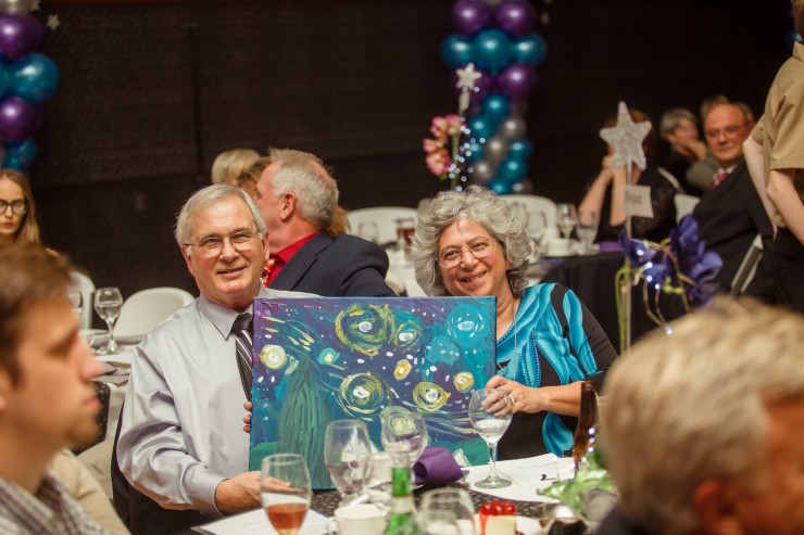 Jim and Ronnie Bogard display the a "Starry Night" painting at last year's Children's Museum Gala. (Submitted photo)